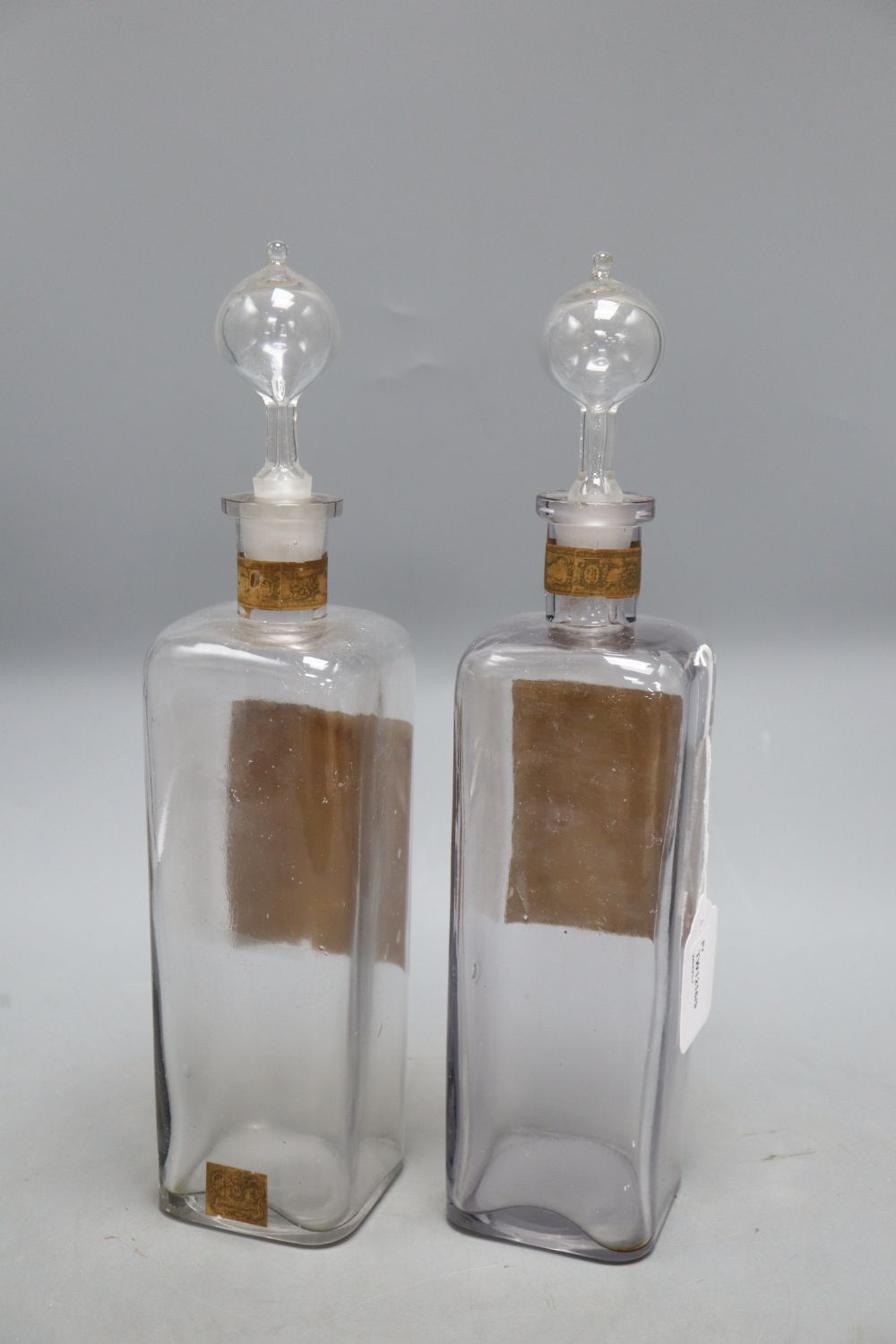 A pair of Morny factice display bottles, Eau de Cologne and Lavender Water, overall height 34cm